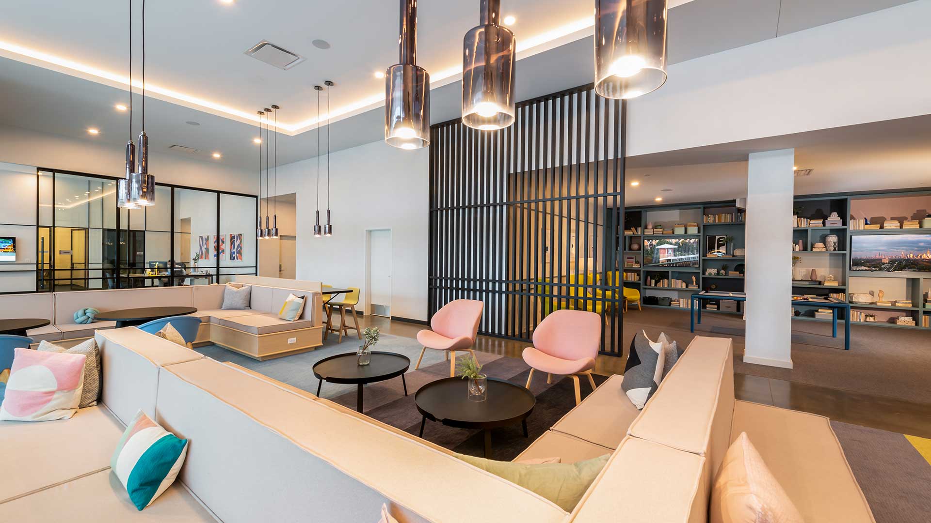 Spacious resident lounge at Eleven33 Apartments in Oak Park featuring modern seating, pendant lighting, and open connection to the game room.